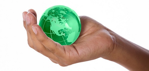 Young boys hand holding a small crystal globe